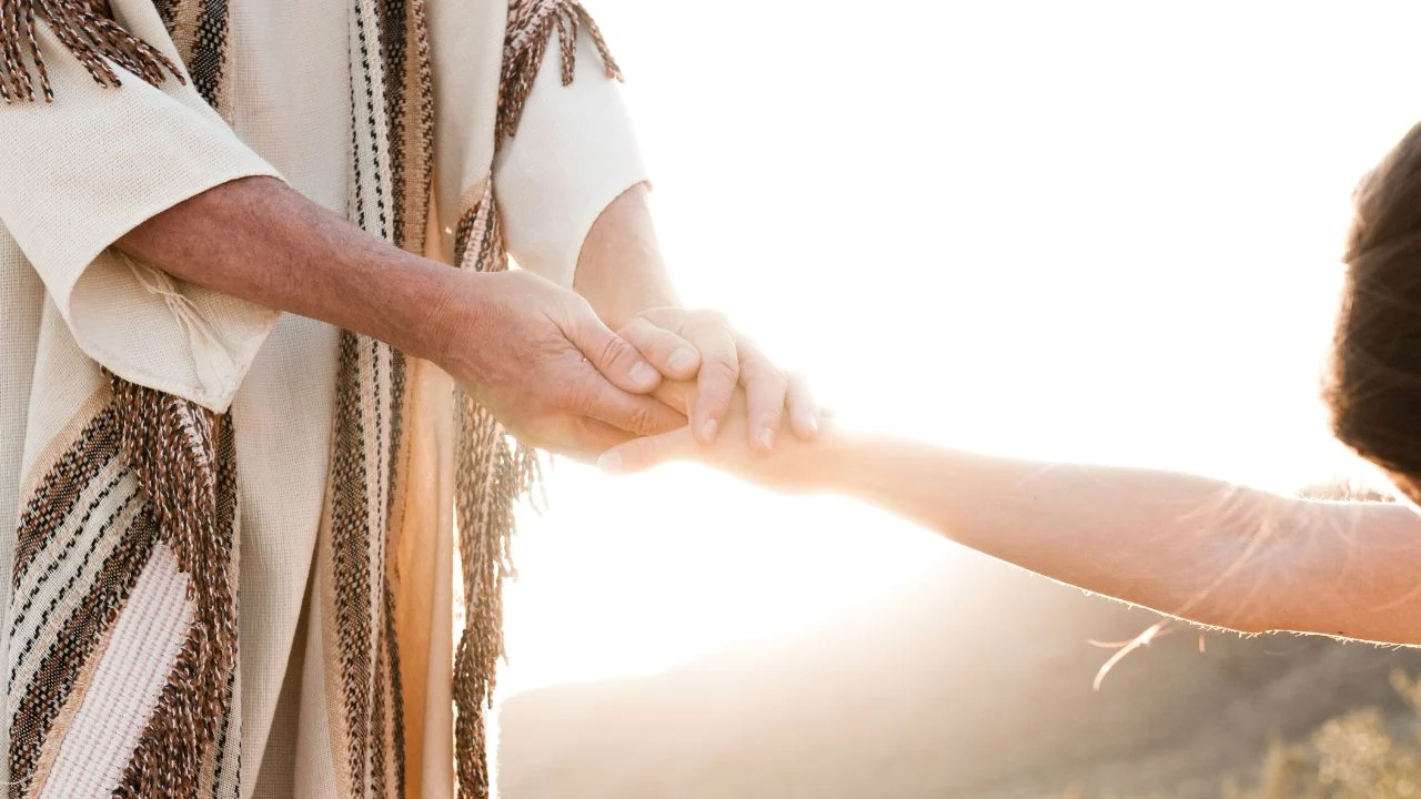 Jesus holding a man's hand