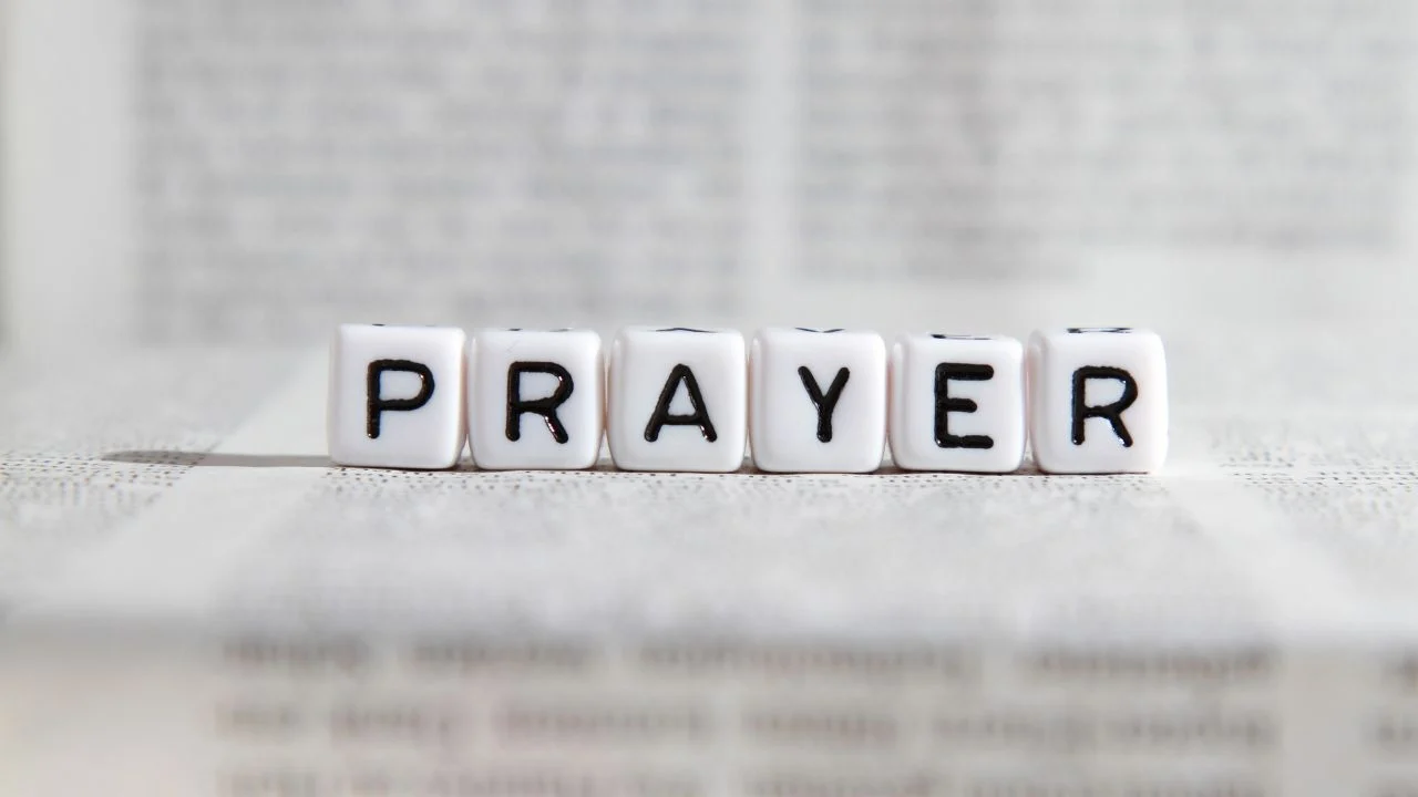 The Word Prayer on a backdrop of the Bible