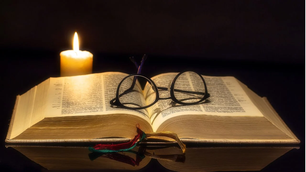Bible, glasses and a candle.