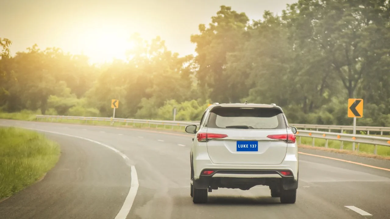White car on the road with the license plate Luke 137