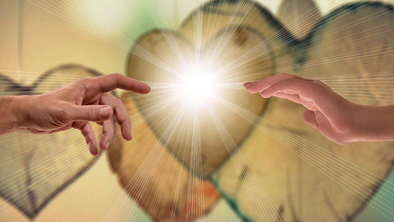 Two hands reaching out to connect with one another