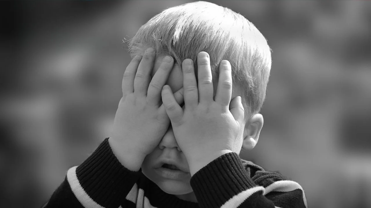 Boy playing hide and seek
