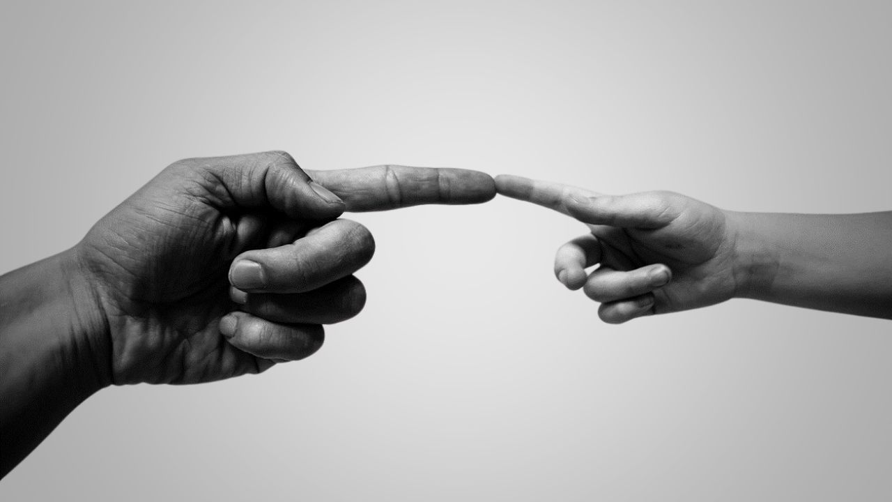 two people touching fingers together